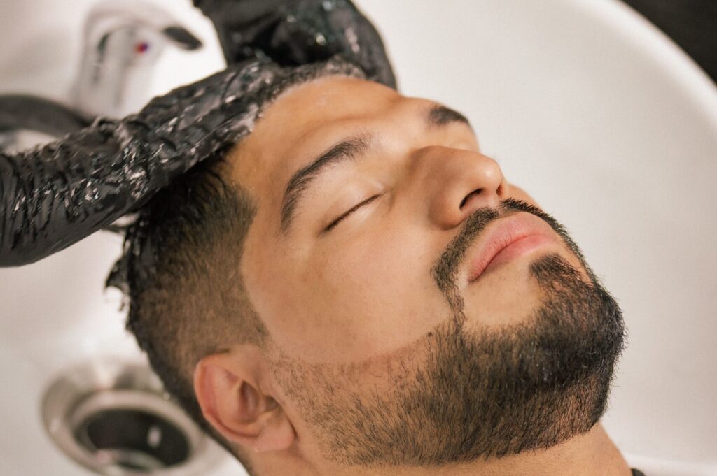 Man receiving a relaxing Japanese head spa treatment with a deep cleansing shampoo and scalp massage to promote scalp wellness and relaxation.